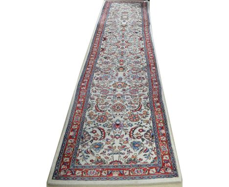 A large vintage 20th-century Persian runner rug, the central cream ground with highly detailed foliate detailing, 82 x 423cm.