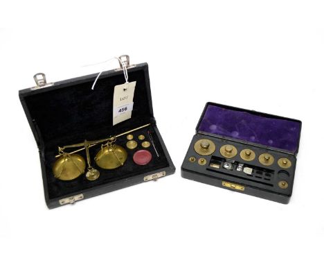 A vintage set of brass travelling scales, with weights, in case; together with a cased set of brass weights. (2)