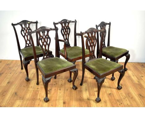 An early 20th Century mahogany extending dining table, with three additional leaves, with moulded edge and raised on acanthus
