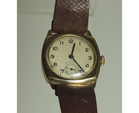 A Gents 9ct gold cased, manual wind wristwatch.  Cushion shaped case.  Circular dial with arabic numerals.  Subsidiary second