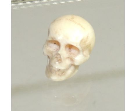 A 19th Century miniature carved ivory skull, approx 1.5cms high