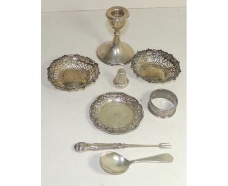 A pair of small silver bon-bon dishes, silver napkin ring, a sterling silver dish, a dwarf silver candlestick, a small pepper