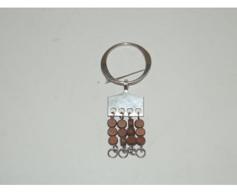 A NORWEGIAN sterling silver brooch by "ANNA GRETA EKER", B.1928 FREDRIKSTAD, probably late 1960's.  Silver with wooden beads.