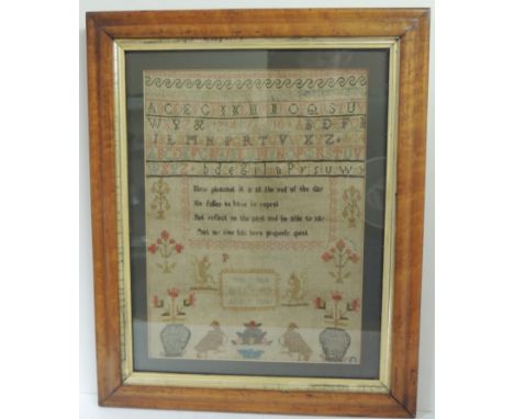 A 19th Century sampler worked with coloured thread with rows of alphabet and numbers, short verse, vases of flowers birds and