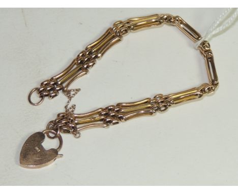 A 9ct gold, three bar gate link type bracelet, with gold padlock clasp and safety chain. 12.6g approx.