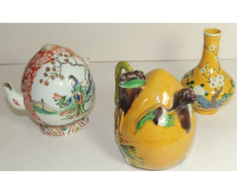 A Chinese peach shaped yellow glazed teapot with bat spout and bat cover, 13.5cms high; a small yellow glazed vase with prunu