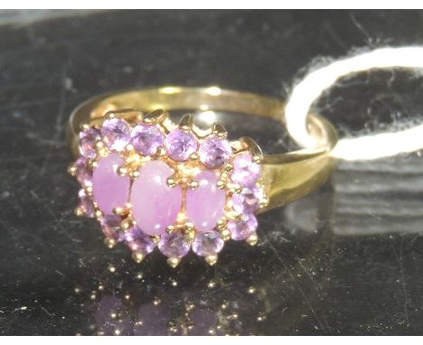 A 9ct gold dress ring set with a cluster of amethyst stones