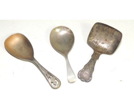 A Victorian caddy spoon with shell terminal, another silver caddy spoon and a silver plated caddy spoon with pierced thistle 