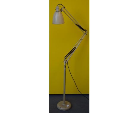 A floor standing angle-poise lamp; designed by George Carwardine.  