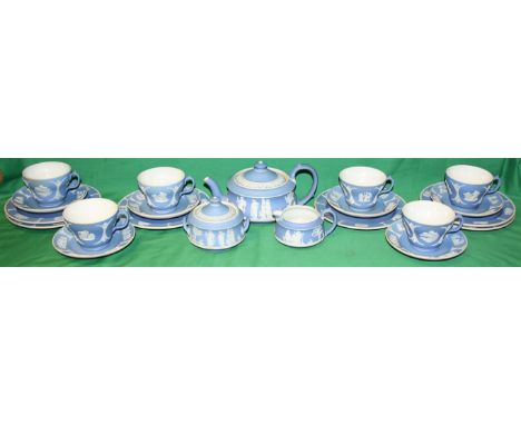 A Wedgwood blue Jasperware tea set.  Comprising of six teacups and saucers, six tea plates, cream jug and covered sugar bowl,