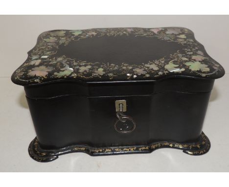 A Victorian papier mache tea caddy with mother of pearl inlay and painted decoration, the hinged lid enclosing two lidded com