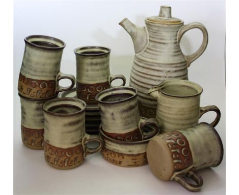 A Tremar Pottery coffee set; comprising of a coffee pot, cream jug, sugar bowl, six cups and saucers.
