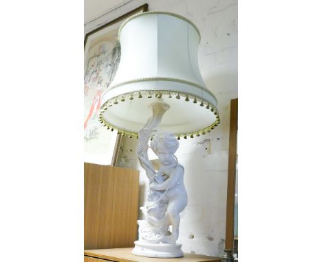 A cream plaster Cupid table lamp with shade 