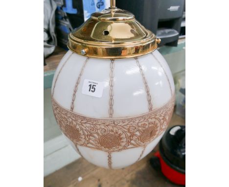 A long hanging electric light fitting with shade