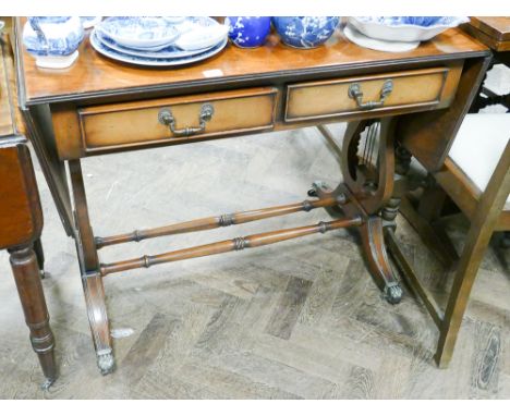 A reproduction mahogany drop leaf sofa style table