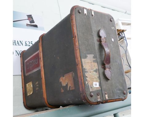 A brown canvass cabin trunk