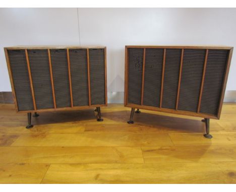 A pair of mid-20th Century oak cased speakers raised on round tapering legs, attributed to Wharfedale, each speaker approx 70