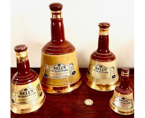 FOUR BELL FORM FLAGON SCOTCH WHISKY BY WADE POTTERY, UNOPENED. ONE STOPPER DAMAGED - CORK SNAPPED