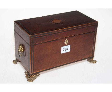 19th Century inlaid mahogany two compartment tea caddy raised on brass paw feet with lion mask handles.