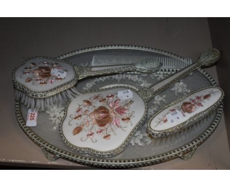 A vintage dressing table set with lace work design.