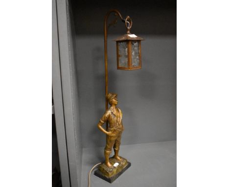 An early 20th century French figural lamp base of a boy under a street lantern.
