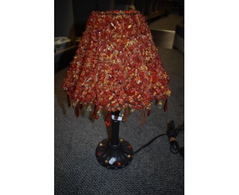A vintage kitsch lamp with metal base and plastic crystal shade.