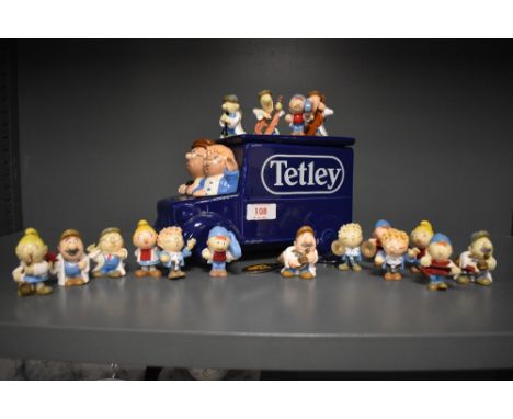 A collection of vintage Tetley tea advertising figures and a van form biscuit barrel.