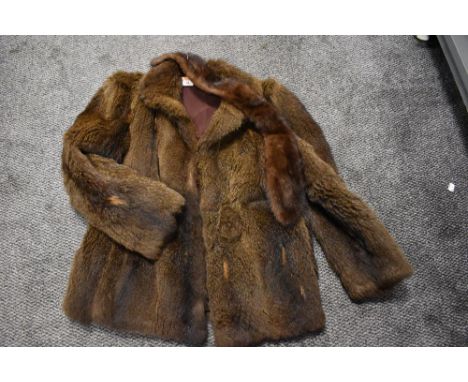 A vintage ladies brown fur coat with a matching stole.