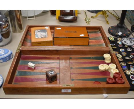 An early 20th century Backgammon games compendium with bridge cards and counter tokens.