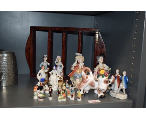 A selection of miniature ceramic figure studies including Hansi and two Capodimonte figures.