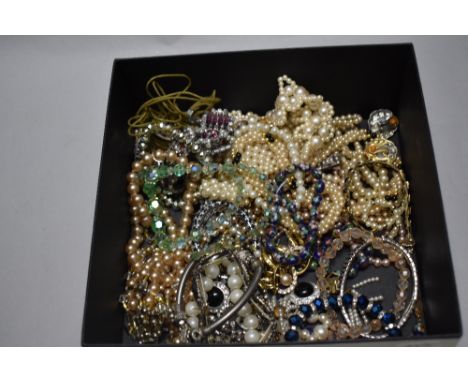 A collection of assorted simulated pearl necklaces.