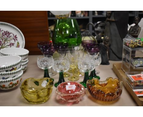 Three art glass trinket dishes with four green stem wine glasses, five yellow stem glasses and a large green tripod footed br