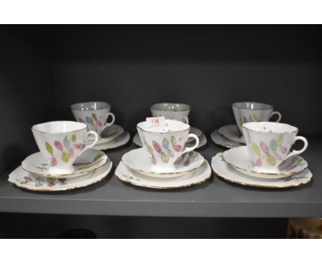 A set of six vintage hand painted porcelain tea cup and saucer trios.