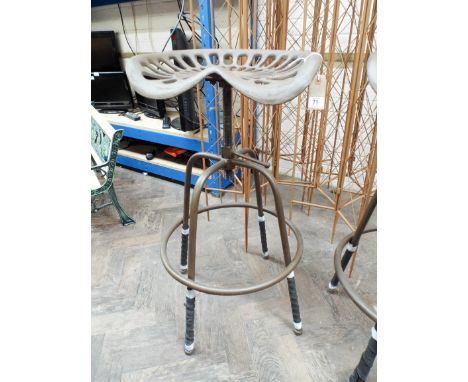 An adjustable cast iron tractor seat 