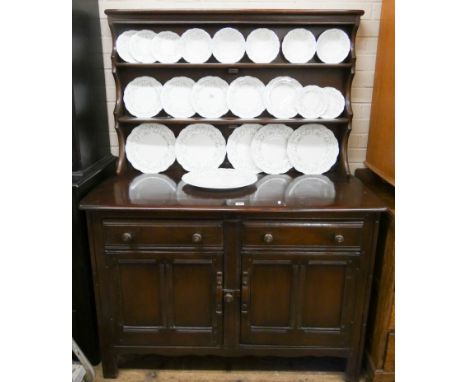 An Ercol dark oak dresser with closed panel back, two drawers and cupboards under  