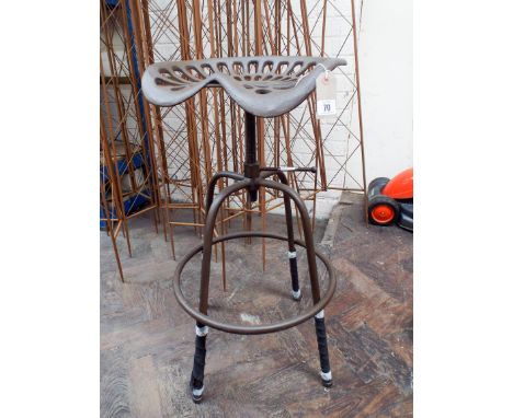 An adjustable cast iron tractor seat 