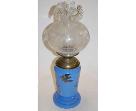 A Victorian opalescent glass oil lamp, having frilled glass shade