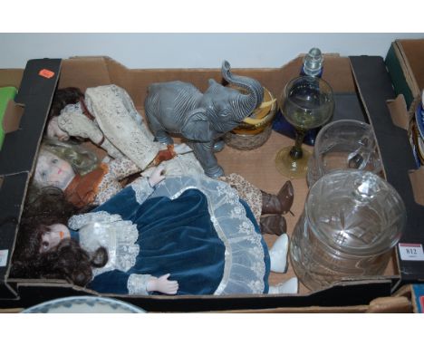 A box of miscellaneous items to include two modern bisque head collectors dolls, ceramic figure of an elephant, glass biscuit