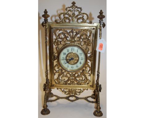 A decorative Victorian pierced brass mantel clock, having an enamelled dial with Arabic numerals, stamped RD152580 verso