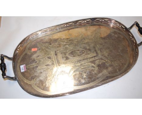 A Victorian silver plated twin handled gallery tray, engraved with Grecian urns and fruiting vines within a pierced swag and 