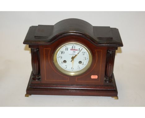 An Edwardian mahogany cased mantel clock of architectural form having an enamelled dial with Arabic numerals and eight day mo