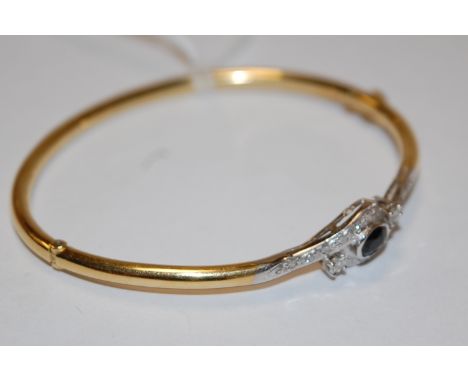 An 18ct gold, sapphire and diamond set hinged bangle   Condition Report / Extra Information  Weight 10.3g.