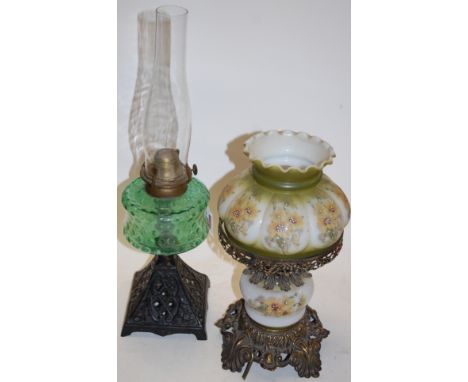A Victorian oil lamp, having opalescent glass shade painted with flowers, on a pierced brass base; together with a green glas