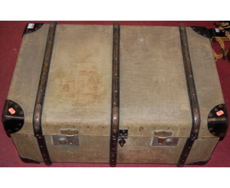 An early 20th century canvas clad travelling trunk, having fitted interior; together with one other leather clad case (2)