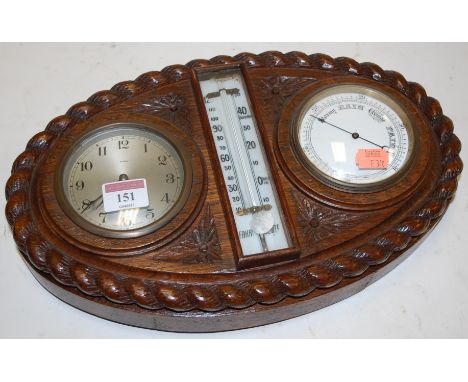 A late Victorian oak cased clock barometer, having central thermometer flanked by two dials, within ropetwist surround 