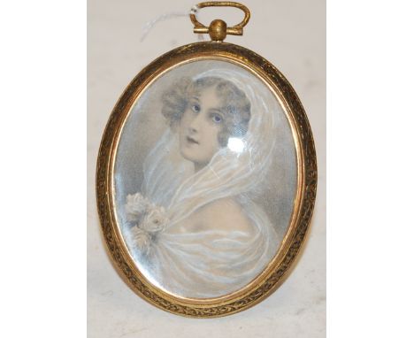 A Victorian portrait miniature being a tinted print in a brass easel mount 