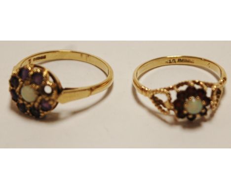 A ladies 9ct gold, opal and garnet set flower head cluster ring; and one other similar opal and amethyst example (one stone m