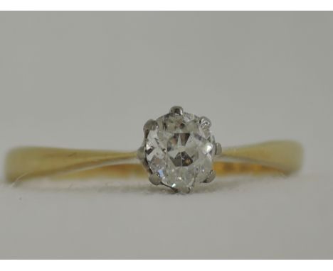 A lady's dress ring having a diamond solitaire, approx .25ct in a claw mount to knife blade shoulders on a yellow metal loop 