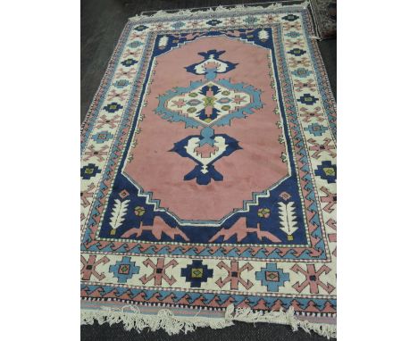 A 1996 carpet square of Turkish design having pink, blue and cream ground, with original certificate and receipt, 104'x71'