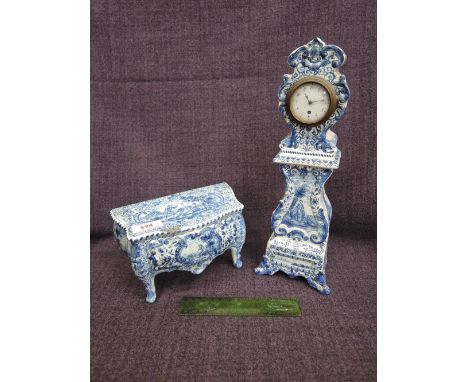 A 19th century Delft miniature model of a commode of bombe shape, with drawer and typical blue and white decoration, marked J